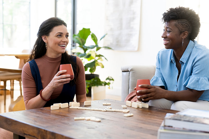 Two women drinking wine and playing games