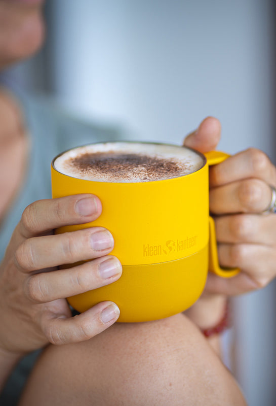 Hands holding Klean coffee mug