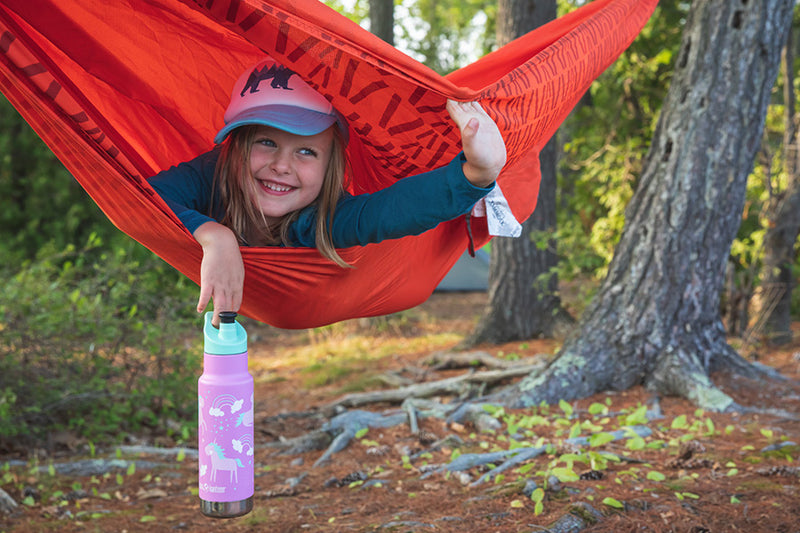 Girl in hammock with water bottle