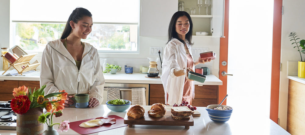 Mom and daughter in kitchen making dinner and meals